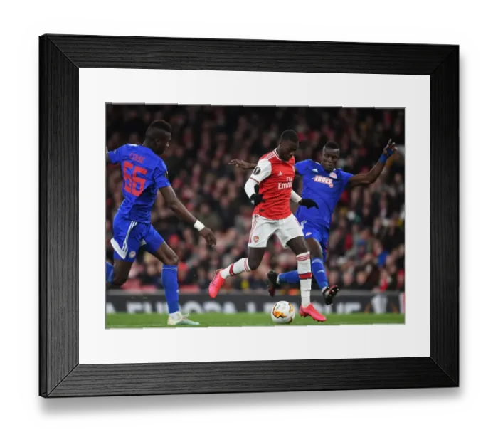Framed Print : Arsenal's Nicolas Pepe Outwits Pape Abou Cisse: Europa League Thriller at Emirates Stadium