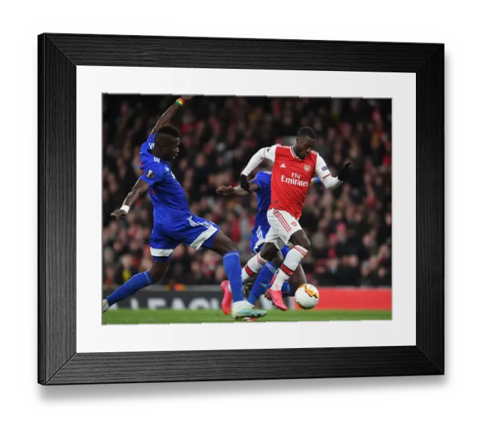 Framed Print : Arsenal's Nicolas Pepe Outsmarts Pape Abou Cisse: Thrilling Europa League Clash at Emirates Stadium