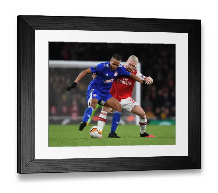 Framed Print : Arsenal vs Olympiacos: Mustafi Clashes with El Arabi in Europa League Showdown Framed Print : Arsenal vs Olympiacos: Mustafi Clashes with El Arabi in Europa League Showdown
