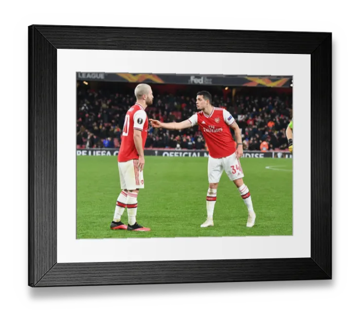 Framed Print : Arsenal's Mustafi and Xhaka in Action: A Europa League Battle against Olympiacos Framed Print : Arsenal's Mustafi and Xhaka in Action: A Europa League Battle against Olympiacos