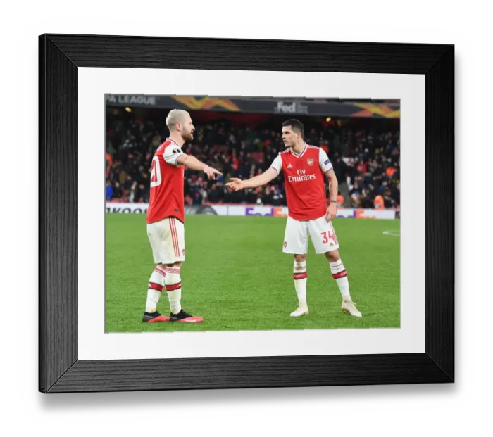 Framed Print : Arsenal's Mustafi and Xhaka Clash in Europa League Battle Against Olympiacos