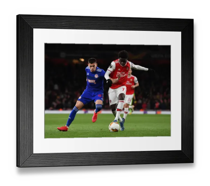 Framed Print : Arsenal's Bukayo Saka Clashes with Olympiacos Lazar Randjelovic in Europa League Showdown Framed Print : Arsenal's Bukayo Saka Clashes with Olympiacos Lazar Randjelovic in Europa League Showdown