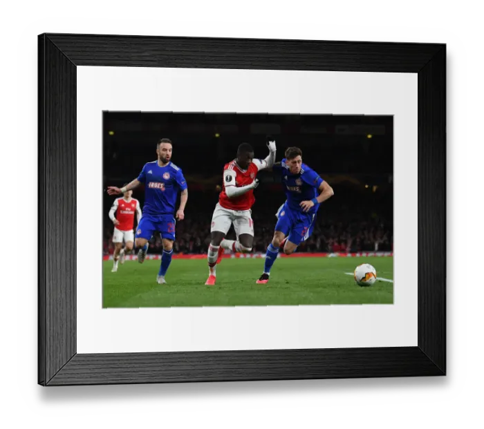 Framed Print : Arsenal's Nicolas Pepe Clashes with Olympiacos Kostas Tsimikas in Europa League Showdown