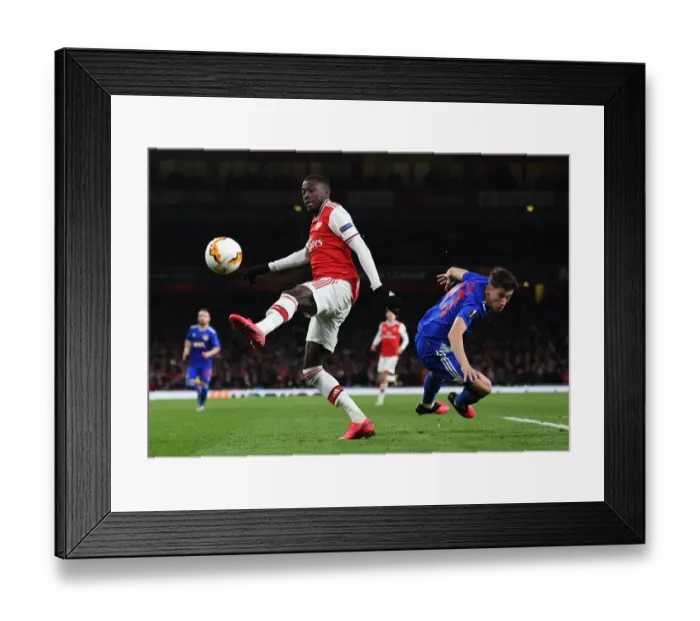 Framed Print : Arsenal vs Olympiacos: Pepe Faces Off Against Tsimikas in Europa League Clash