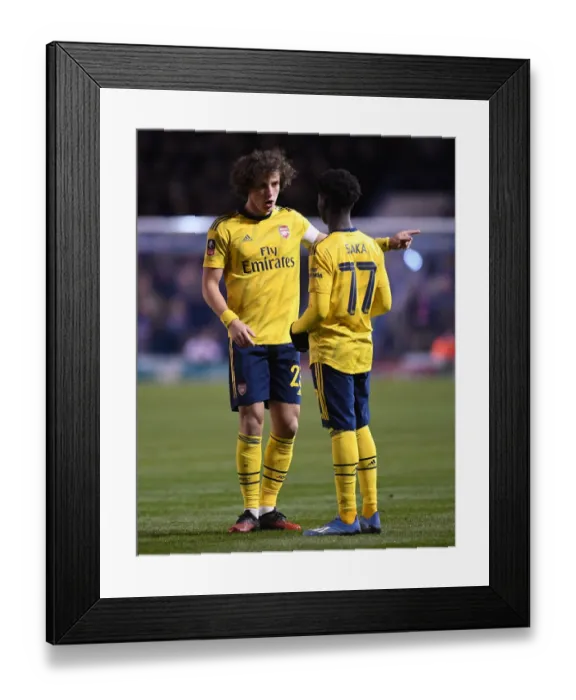 Framed Print : Arsenal's David Luiz Guides Bukayo Saka during FA Cup Clash vs Portsmouth Framed Print : Arsenal's David Luiz Guides Bukayo Saka during FA Cup Clash vs Portsmouth