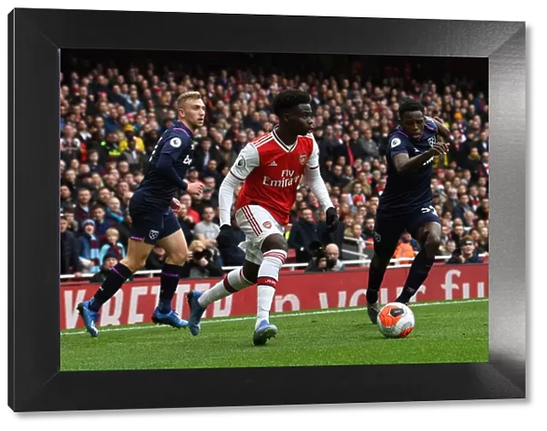 Arsenal's Bukayo Saka Faces Off Against West Ham's Jeremy Ngakia in Premier League Clash