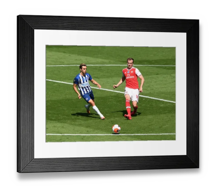 Framed Print : Brighton vs. Arsenal: Holding Defends Amidst Trossard Pressure (Premier League 2019-20)
