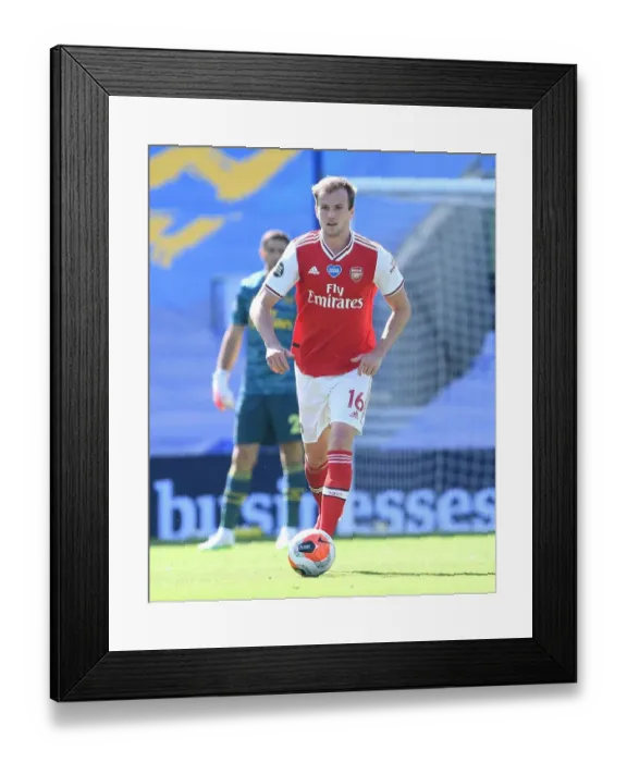 Framed Print : Empty Stands: Arsenal's Rob Holding in Action against Brighton & Hove Albion (2019-2020) Framed Print : Empty Stands: Arsenal's Rob Holding in Action against Brighton & Hove Albion (2019-2020)