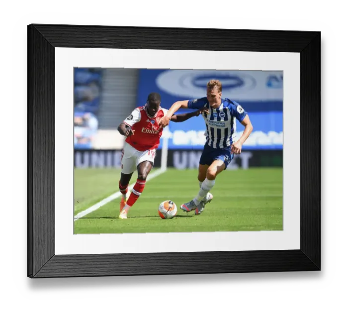 Framed Print : Brighton vs. Arsenal: Pepe Takes on Burn in Empty Premier League Clash (2019-20)