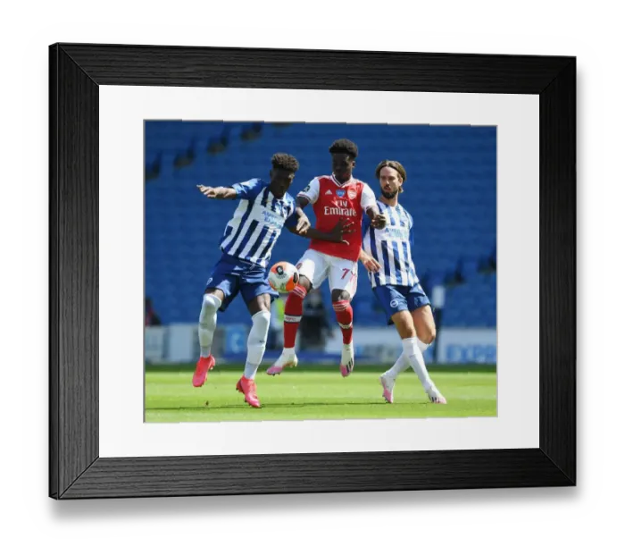 Framed Print : Brighton vs. Arsenal: Empty Stadium Showdown - Bukayo Saka vs. Yves Bissouma