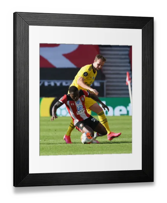 Framed Print : Rising Tensions: Holding vs. Obafemi in Southampton vs. Arsenal Premier League Clash Framed Print : Rising Tensions: Holding vs. Obafemi in Southampton vs. Arsenal Premier League Clash