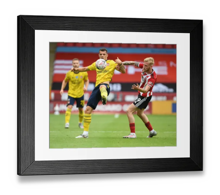 Framed Print : Granit Xhaka vs Olivier McBurnie: Intense Clash in FA Cup Quarterfinal between Sheffield United and Arsenal Framed Print : Granit Xhaka vs Olivier McBurnie: Intense Clash in FA Cup Quarterfinal between Sheffield United and Arsenal