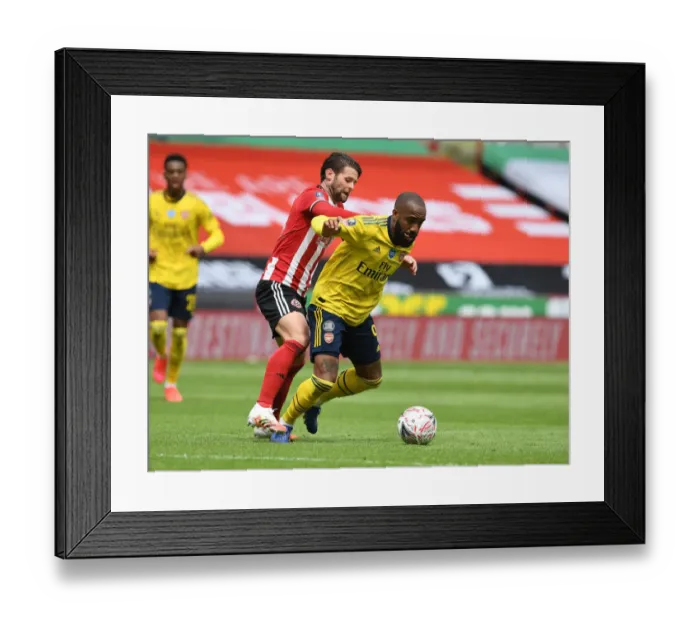 Framed Print : Arsenal's Lacazette Faces Off Against Sheffield United's Egan in FA Cup Quarterfinal Clash Framed Print : Arsenal's Lacazette Faces Off Against Sheffield United's Egan in FA Cup Quarterfinal Clash