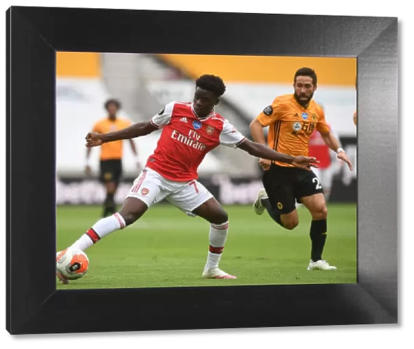 Bukayo Saka vs Joao Moutinho: Intense Battle at Molineux - Wolverhampton Wanderers vs Arsenal FC, Premier League 2019-2020