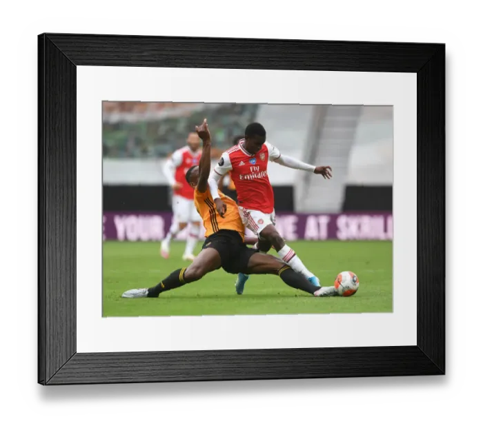Framed Print : Nketiah vs. Boly: A Tense Battle in Wolverhampton Wanderers vs. Arsenal Premier League Clash (2019-20)
