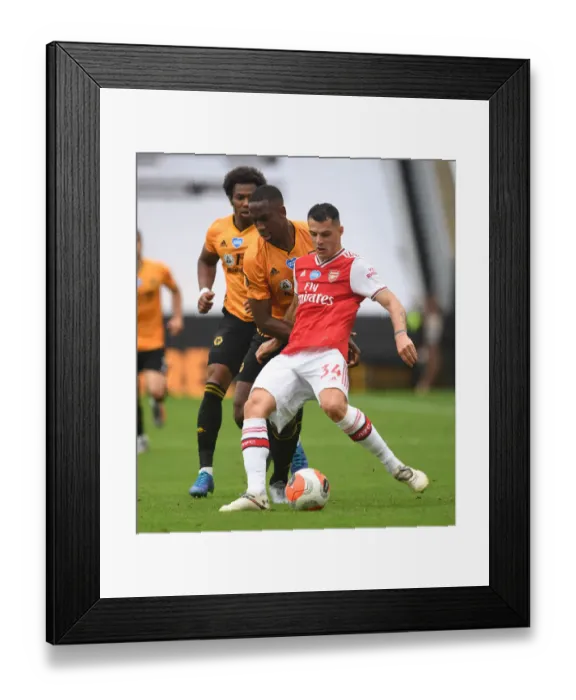 Framed Print : Xhaka vs Bolly: Intense Battle in Wolverhampton Wanderers vs Arsenal FC Premier League Clash