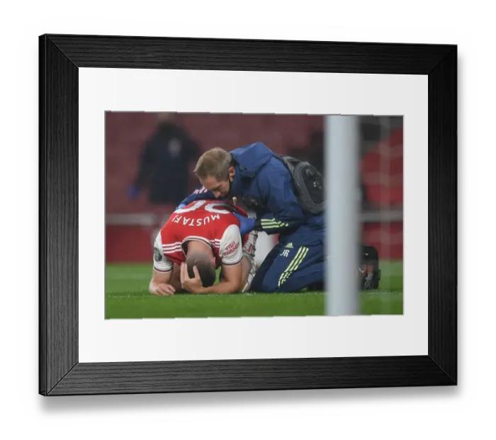 Framed Print : Arsenal's Mustafi Receives Treatment During Arsenal v Leicester City Premier League Match