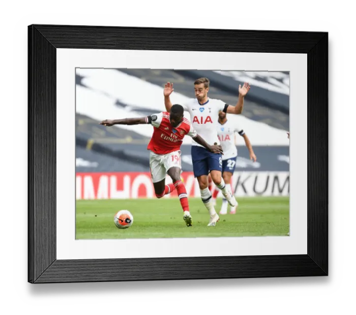 Framed Print : Nicolas Pepe Breaks Past Harry Winks: Intense Moment from Tottenham vs. Arsenal Premier League Clash (2019-20)