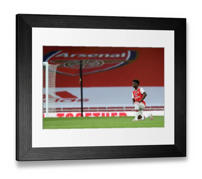 Framed Print : Arsenal's Bukayo Saka Takes a Knee at Empty Emirates Stadium During Arsenal v Liverpool Match, 2019-2020 Premier League Framed Print : Arsenal's Bukayo Saka Takes a Knee at Empty Emirates Stadium During Arsenal v Liverpool Match, 2019-2020 Premier League