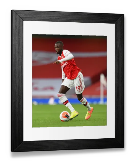 Framed Print : Arsenal's Pepe Faces Liverpool in Empty Emirates Stadium (2019-20) Framed Print : Arsenal's Pepe Faces Liverpool in Empty Emirates Stadium (2019-20)