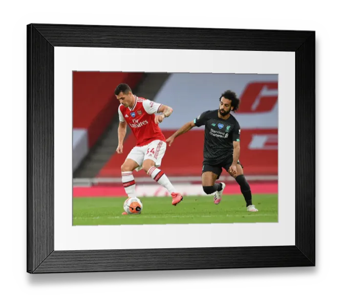 Framed Print : Empty Stadium Showdown: Xhaka vs. Salah - Arsenal vs. Liverpool, Premier League 2019-2020