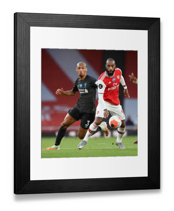 Framed Print : Empty Stadium Showdown: Lacazette vs. Fabinho - Arsenal vs. Liverpool (2019-20): A Battle Unfolds Amidst an Empty Emirates Stadium Framed Print : Empty Stadium Showdown: Lacazette vs. Fabinho - Arsenal vs. Liverpool (2019-20): A Battle Unfolds Amidst an Empty Emirates Stadium
