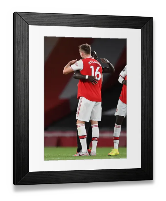 Framed Print : Arsenal vs. Liverpool: Empty-stadium Hug as Premier League Resumes Amidst Coronavirus Pandemic