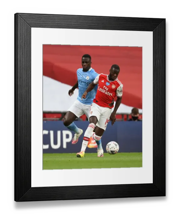 Framed Print : Arsenal's Nicolas Pepe Outsmarts Manchester City's Mendy in FA Cup Semi-Final Thriller Framed Print : Arsenal's Nicolas Pepe Outsmarts Manchester City's Mendy in FA Cup Semi-Final Thriller