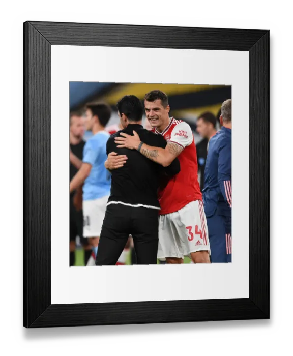 Framed Print : Arsenal's FA Cup Semi-Final Triumph: Mikel Arteta and Granit Xhaka Embrace Victory over Manchester City
