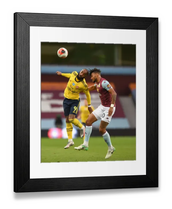 Framed Print : Arsenal's Lacazette Clashes with Villa's Mings in Premier League Showdown