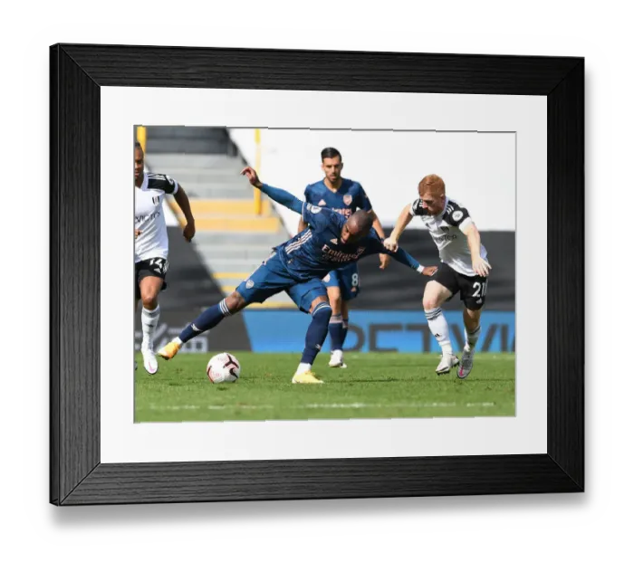 Framed Print : Arsenal's Lacazette Faces Off Against Fulham's Reed in Premier League Clash Framed Print : Arsenal's Lacazette Faces Off Against Fulham's Reed in Premier League Clash