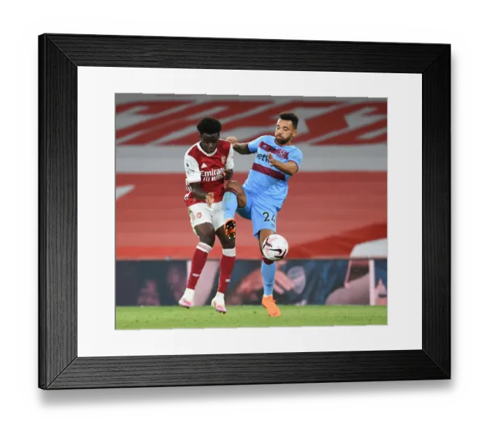 Framed Print : Intense Premier League Clash: Arsenal's Bukayo Saka Fouls West Ham's Ryan Fredericks Framed Print : Intense Premier League Clash: Arsenal's Bukayo Saka Fouls West Ham's Ryan Fredericks