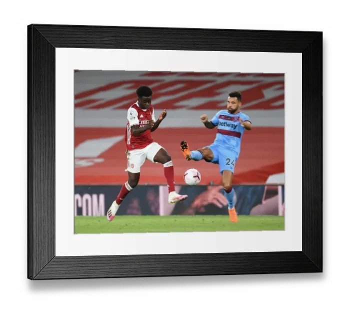 Framed Print : Intense Premier League Clash: Saka vs Fredericks - Foul at Arsenal's Emirates Stadium