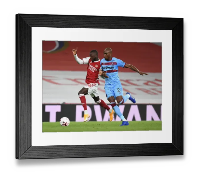 Framed Print : Arsenal's Nicolas Pepe Outmaneuvers West Ham's Angelo Ogbonna in Premier League Clash Framed Print : Arsenal's Nicolas Pepe Outmaneuvers West Ham's Angelo Ogbonna in Premier League Clash