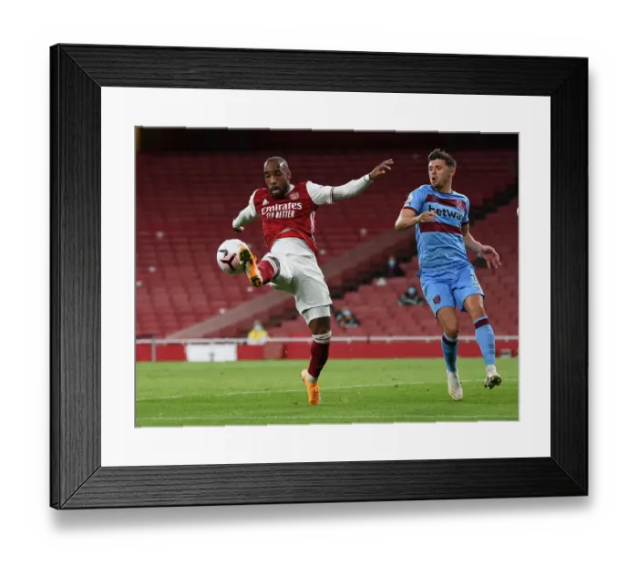 Framed Print : Arsenal vs. West Ham: Lacazette Faces Off Against Cresswell in Premier League Showdown