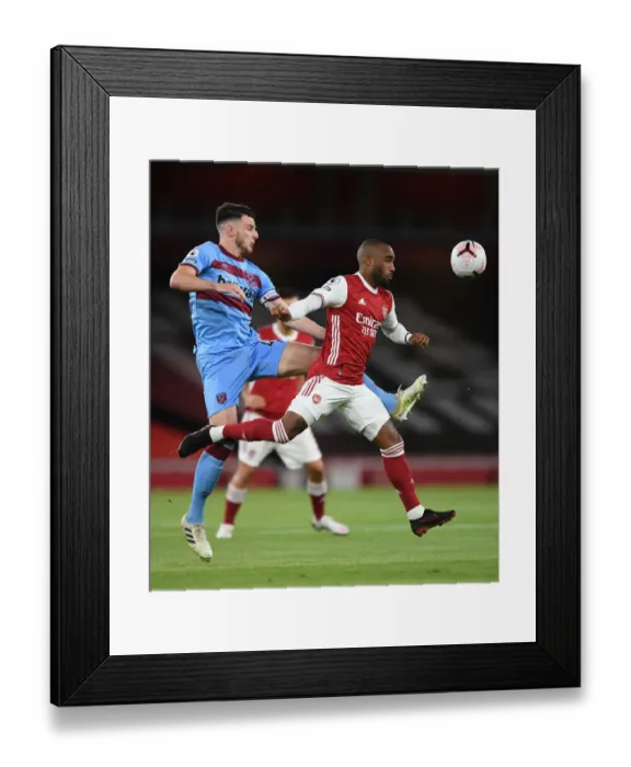Framed Print : Intense Heading Showdown: Lacazette vs. Rice in Arsenal's Battle with West Ham Framed Print : Intense Heading Showdown: Lacazette vs. Rice in Arsenal's Battle with West Ham