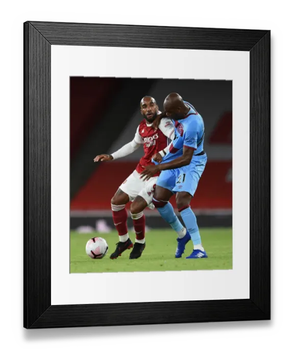 Framed Print : Arsenal vs. West Ham: Lacazette vs. Ogbonna in Intense Battle at Emirates Stadium Framed Print : Arsenal vs. West Ham: Lacazette vs. Ogbonna in Intense Battle at Emirates Stadium