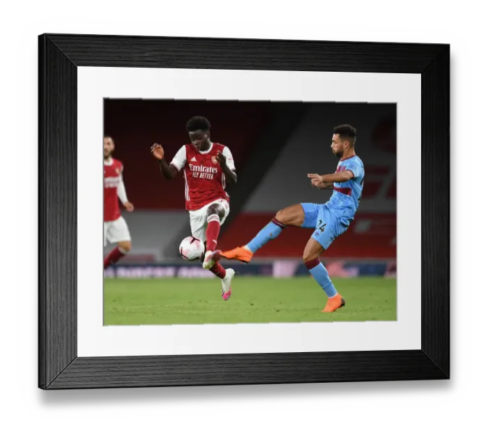 Framed Print : Arsenal vs. West Ham: Saka vs. Fredericks - Premier League Showdown at Emirates Stadium