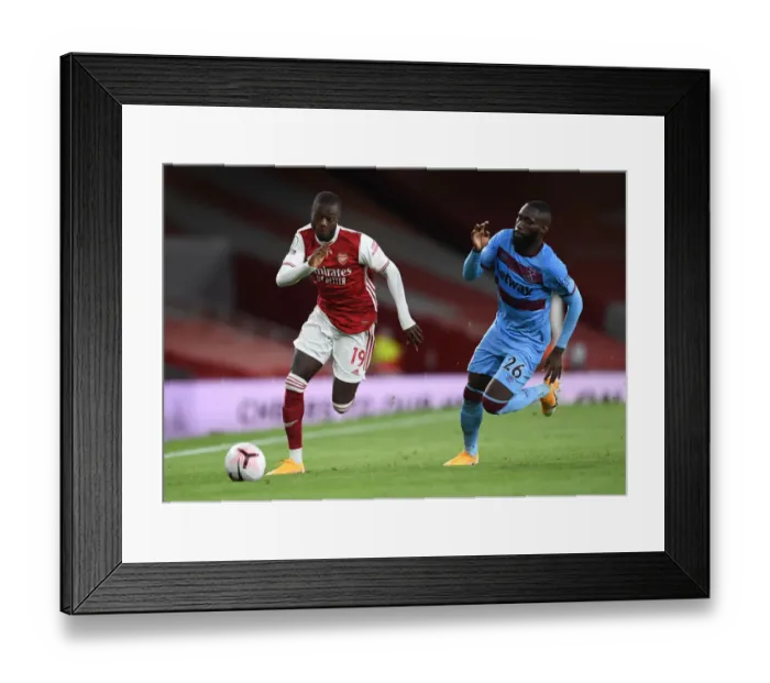 Framed Print : Arsenal's Pepe Clashes with West Ham's Masuaka in Premier League Showdown