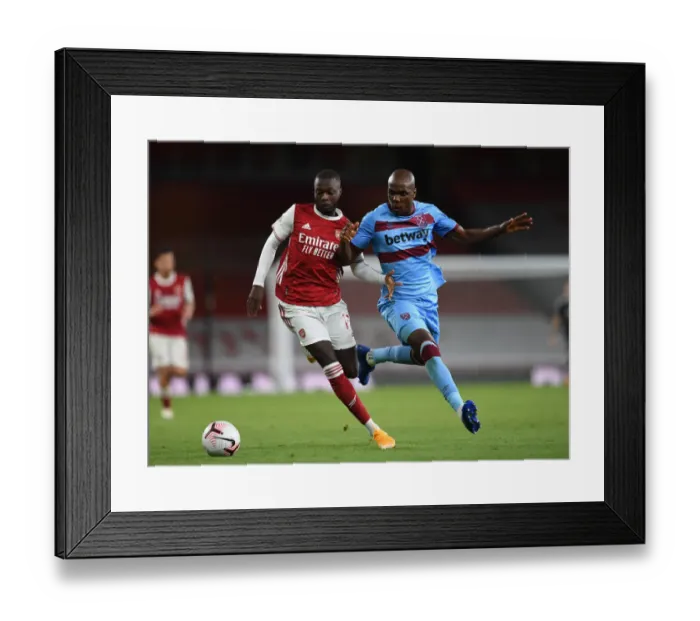 Framed Print : Pepe vs. Ogbonna: Intense Clash in Arsenal's Battle Against West Ham Framed Print : Pepe vs. Ogbonna: Intense Clash in Arsenal's Battle Against West Ham