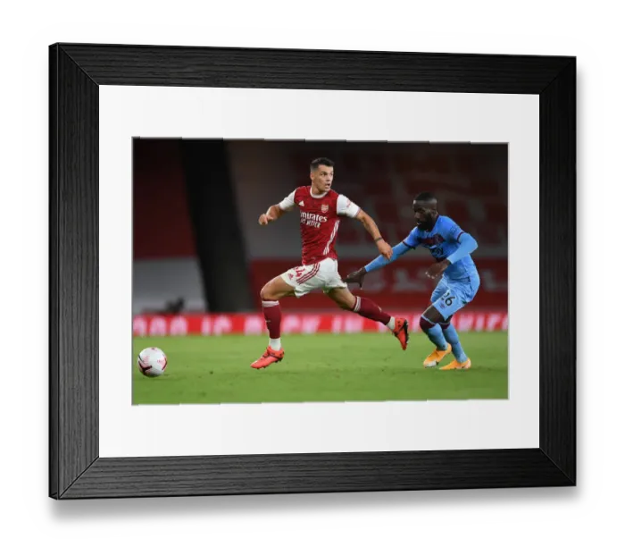 Framed Print : Arsenal's Xhaka Clashes with West Ham's Masuaka in Premier League Showdown