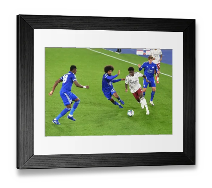 Framed Print : Arsenal's Bukayo Saka Faces Off Against Leicester City's Daniel Amartey and Hamza Choudhury in Carabao Cup Clash Framed Print : Arsenal's Bukayo Saka Faces Off Against Leicester City's Daniel Amartey and Hamza Choudhury in Carabao Cup Clash