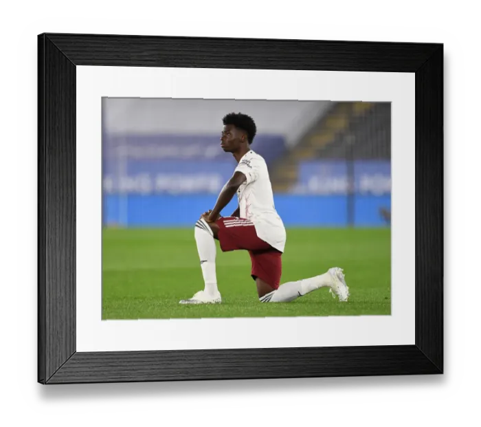 Framed Print : Arsenal's Bukayo Saka Takes a Knee During Leicester City vs Arsenal Carabao Cup Match Framed Print : Arsenal's Bukayo Saka Takes a Knee During Leicester City vs Arsenal Carabao Cup Match