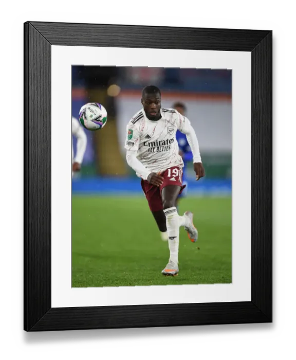 Framed Print : Arsenal's Nicolas Pepe Goes Head-to-Head with Leicester City in Carabao Cup Clash