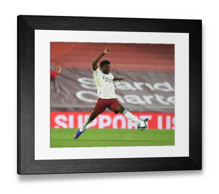 Framed Print : Empty Anfield Rivalry: Bukayo Saka Leads Arsenal Against Liverpool in Coronavirus-hit Carabao Cup