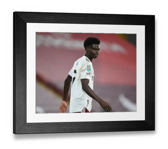 Framed Print : Empty Anfield Showdown: Bukayo Saka Leads Arsenal Against Liverpool in Carabao Cup Clash Amidst Pandemic