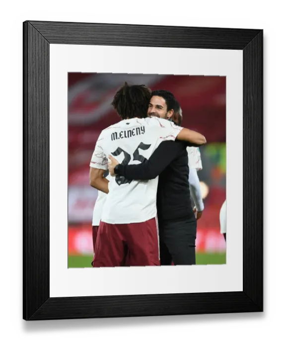 Framed Print : Mikel Arteta Embraces Mo Elneny: Liverpool vs Arsenal in Empty Anfield - Carabao Cup 2020-21