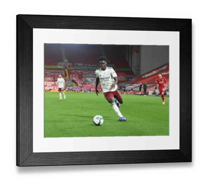 Framed Print : Empty Anfield: Bukayo Saka Leads Arsenal Against Liverpool in Carabao Cup Clash Amidst Pandemic