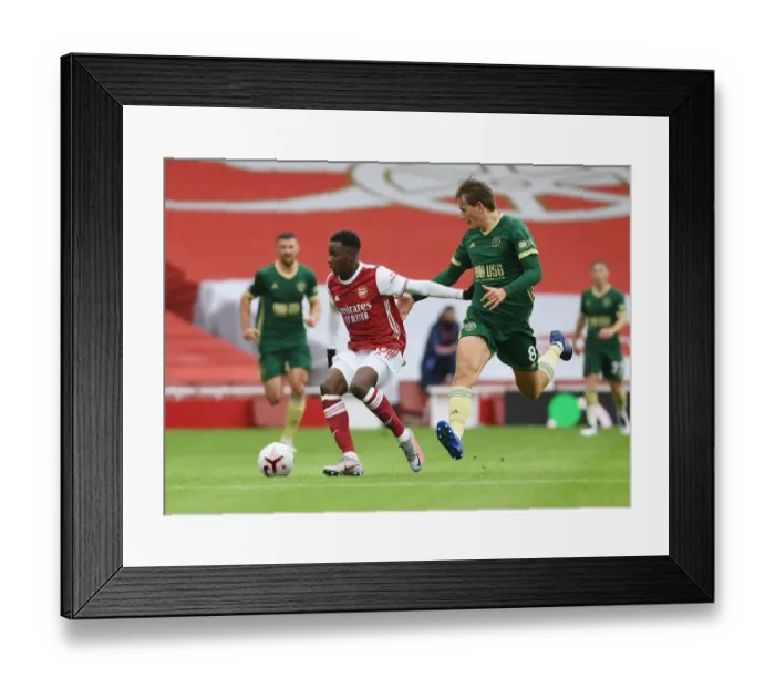 Framed Print : Arsenal vs Sheffield United: Nketiah Takes on Berge in Empty Emirates Stadium, Premier League 2020-21 Framed Print : Arsenal vs Sheffield United: Nketiah Takes on Berge in Empty Emirates Stadium, Premier League 2020-21