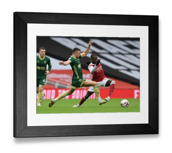 Framed Print : Arsenal's Nicolas Pepe Outmaneuvers Sheffield United's Jack Robinson in Empty Emirates Stadium Framed Print : Arsenal's Nicolas Pepe Outmaneuvers Sheffield United's Jack Robinson in Empty Emirates Stadium